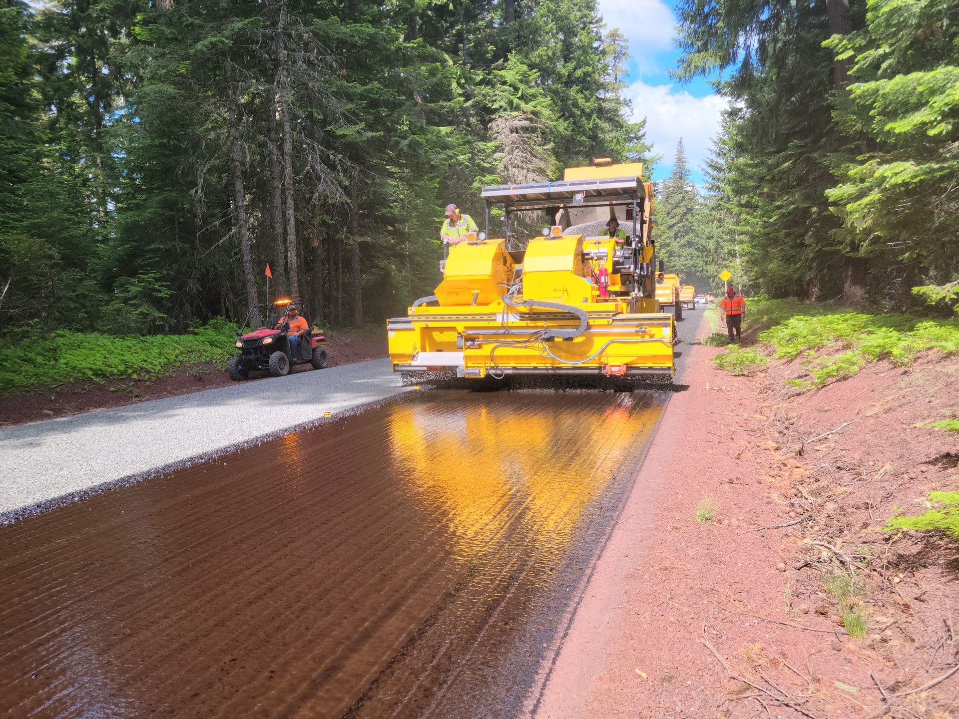 Paving crew laying fresh asphalt