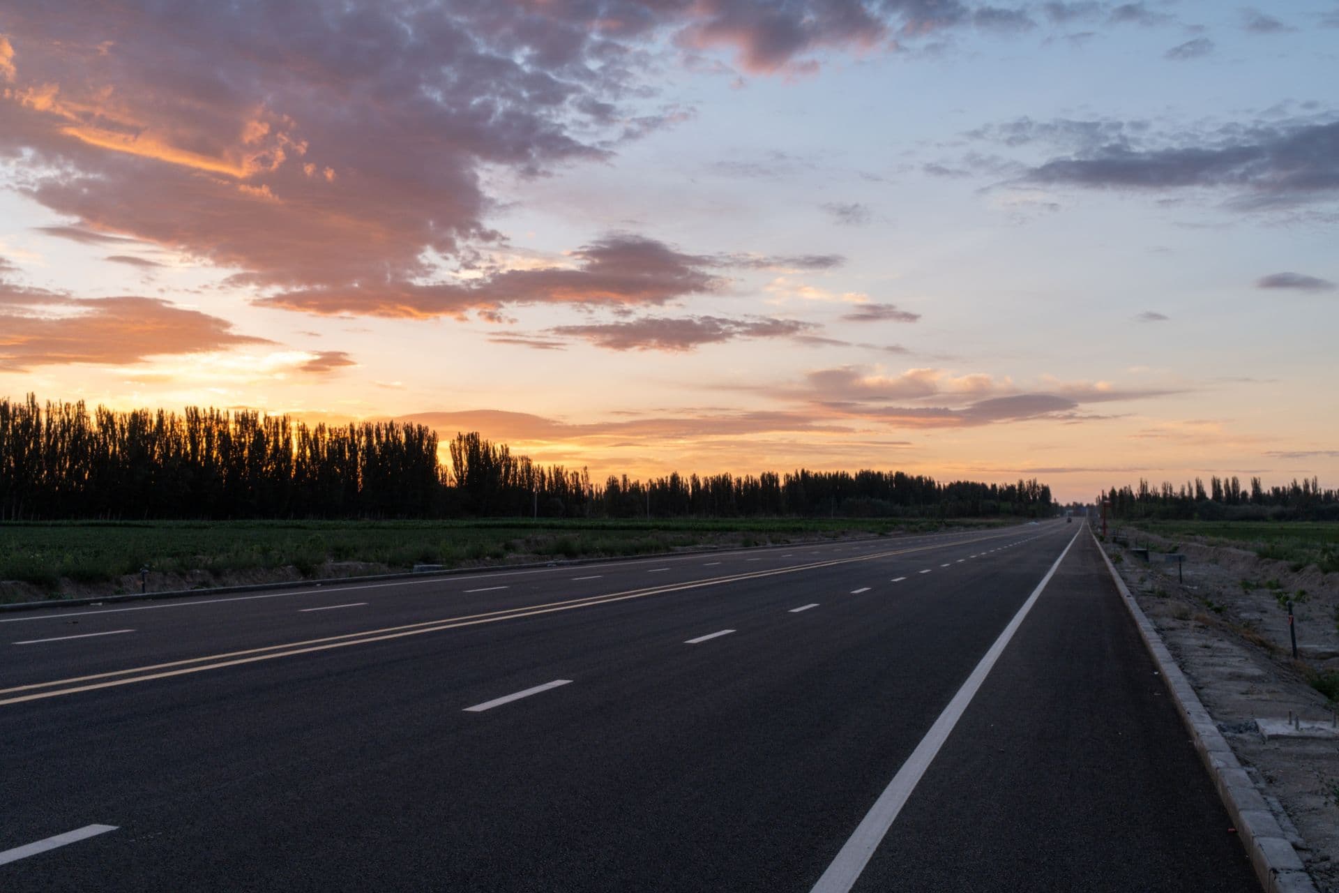 Smooth new asphalt highway at dusk